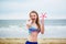 Happy young woman in bikini with snorkelling equipment and pink starfish