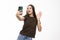 Happy young woman blogger influencer holding modern smart phone wave hand hello