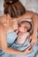 Happy young woman breastfeeding and hugging baby. Lactation newborn concept