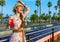 Happy young woman with bright red beverage having fun time