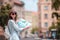 Happy young woman with a city map in city. Travel tourist woman with map in Prague outdoors during holidays in Europe.
