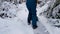 Happy young woman cleans snow in the garden near the house. Portrait of a girl with a snow shovel in her hands. Happy girl removes