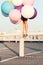 Happy young woman with colorful latex balloons