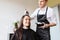 Happy young woman coloring hair at salon