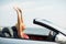 Happy young woman in convertible car