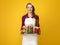 Happy young woman cook showing jars of marinated vegetables