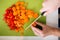 Happy young woman cutting fresh vegetables in kitchen