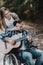 Happy Young Woman and Disabled Man with Guitar