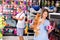 Happy young woman with dog in pet store during shopping with man