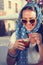 Happy young woman drinking iced coffee in restaurant