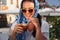 Happy young woman drinking iced coffee in restaurant