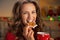 Happy young woman eating christmas snacks
