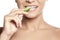 Happy young woman eating cucumber. Healthy smile with white teeth