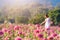 Happy young woman enjoying summer in zinnia field.