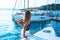 Happy young woman feels fun on the luxury sail boat yacht catamaran in turquoise sea in summer holidays on island Greece