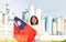 Happy young woman with flag of Taiwan against background of factory