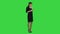 Happy young woman flattered by compliments sent to her mobile phone on a Green Screen, Chroma Key