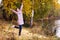 Happy young woman in forest rejoices