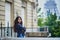 Happy young woman in front of the Eiffel tower