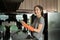 Happy young woman in gloves doing household washing dishes at home kitchen