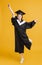 Happy young woman in graduation gowns and dancing