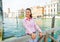 Happy young woman on grand canal in venice, italy