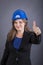 Happy young woman with hardhat showing ok sign