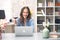 Happy young woman having video chat, wearing Easter bunny ears at home, video calling, using laptop computer, tasting wine