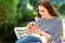 Happy young woman with her cavalier puppy sitting outdoor