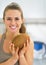 Happy young woman holding coconut