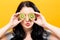 Happy young woman holding kiwis