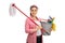 Happy young woman holding mop and bucket filled with cleaning pr