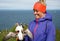 Happy young woman holding puffin in Iceland