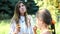 Happy young woman hugs her daughter outdoors with a smile. Mother and her grown up daughter