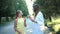 Happy young woman hugs her daughter outdoors with a smile. Mother and her grown up daughter