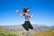 Happy Young woman jumping with Mt Aspiring landscape view in Wanaka, New Zealand