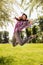 Happy young woman jumping in park