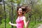 Happy young woman jumping with a skipping rope in a summer park