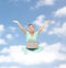 Happy young woman with laptop sitting on cloud