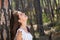 Happy young woman laughing in the woods