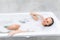 Happy young woman laying in bathtub view from above