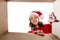 Happy young woman looking into open christmas gift