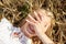 Happy young woman lying on cereal field