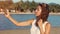 Happy young woman making selfie on seaside beach