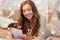 Happy young woman with notebook in bed at home