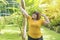 Happy young woman overweight stretching before workout in the garden. Fat girl obesity stretch arm warm up before exercising in