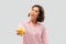 Happy young woman in pajama holding orange juice