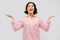 Happy young woman in pajama shrugging