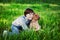 Happy young woman playing with dog Shar Pei in the green grass, true friends forever