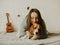 Happy young woman playing with her dog on a white background. Beagle dog with owner. Girl and dog at home